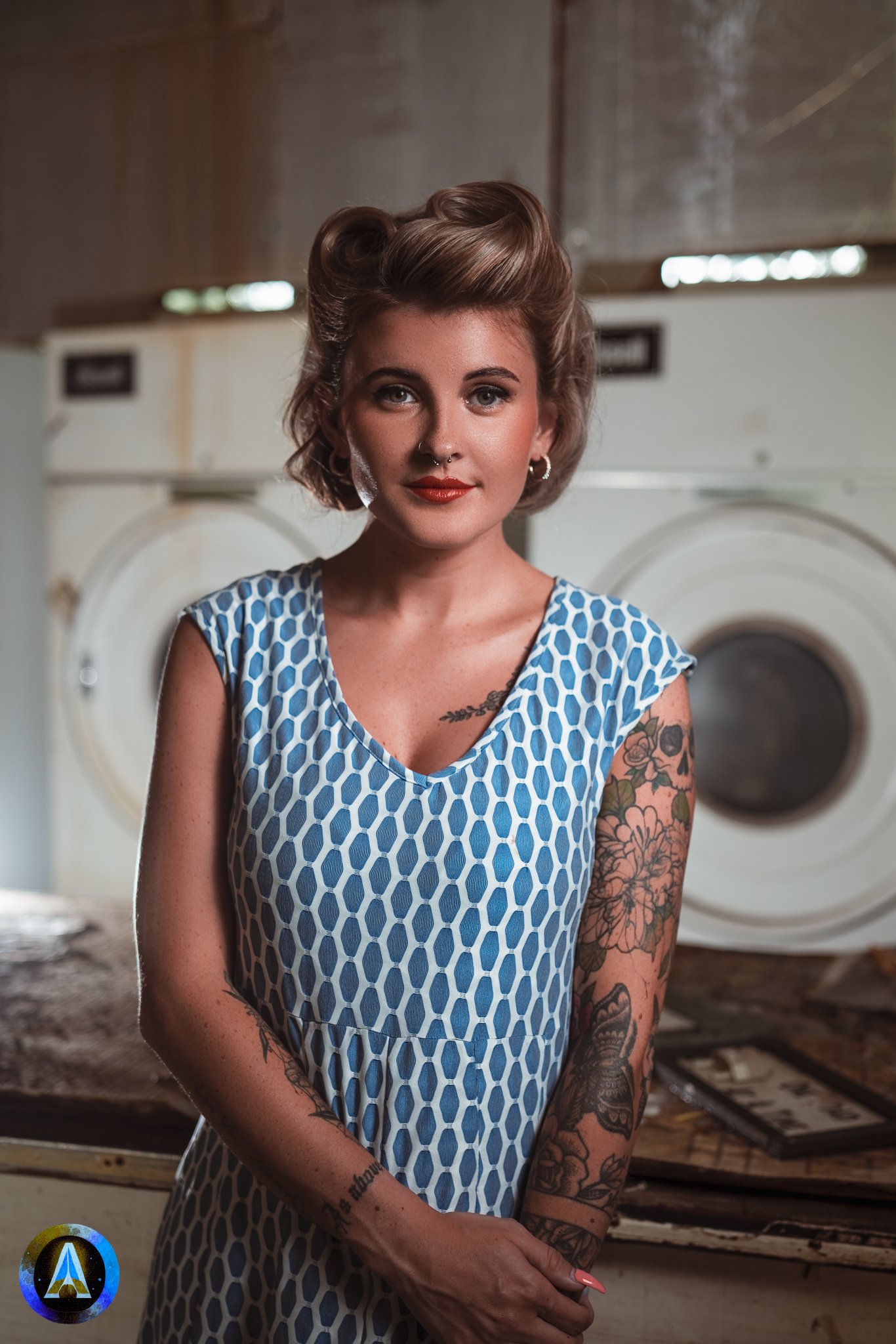 Blonde model courtney france poses in an abandoned shop / laundromat in pinup attire.