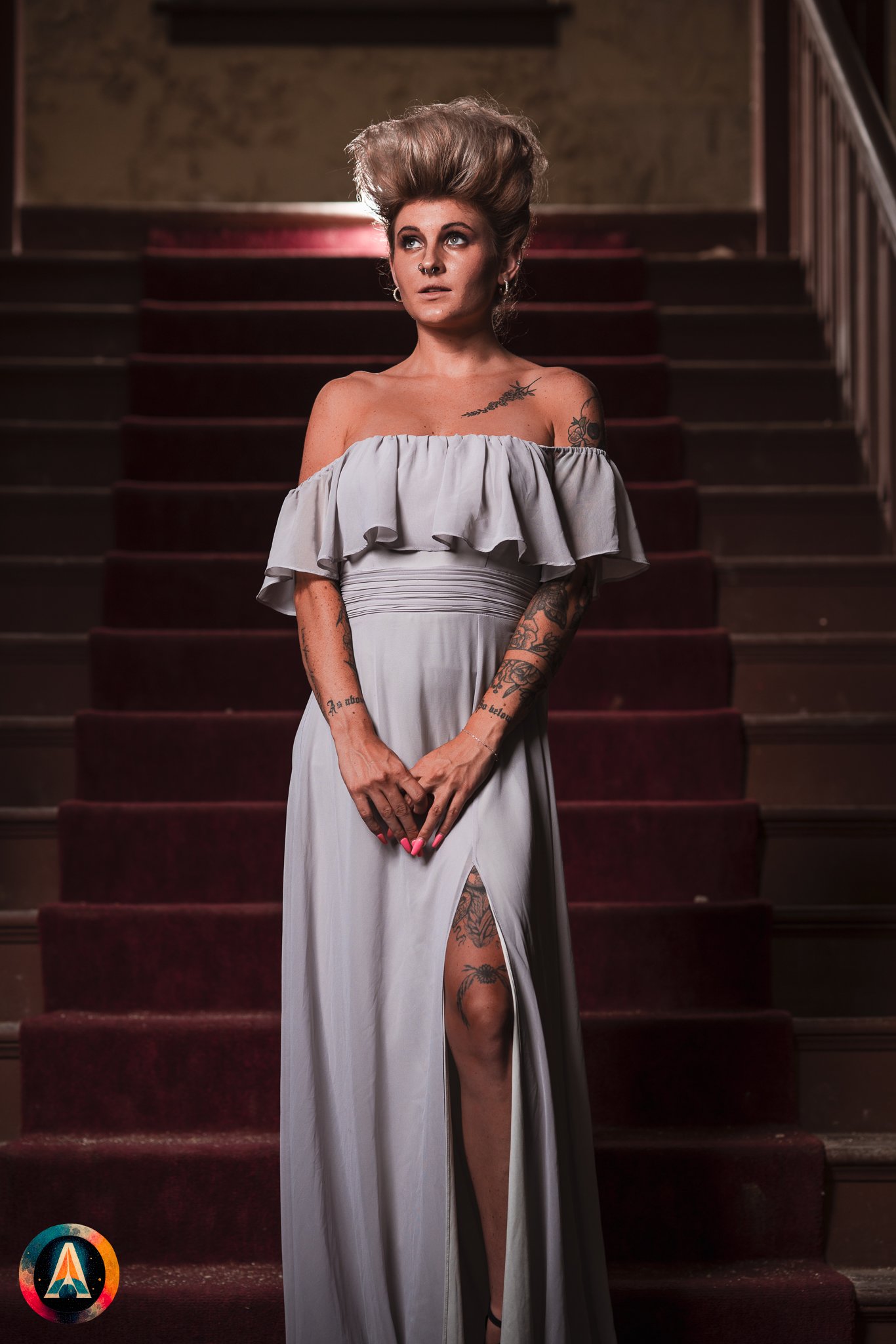 Blonde model courtney france poses in the haunted indiana state sanitarium shop / hair salon in a elegant blue dress.