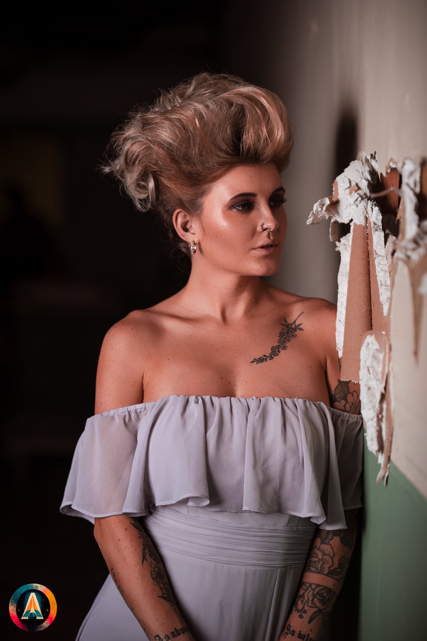 Blonde model courtney france poses in the haunted indiana state sanitarium shop / hair salon in a elegant blue dress.