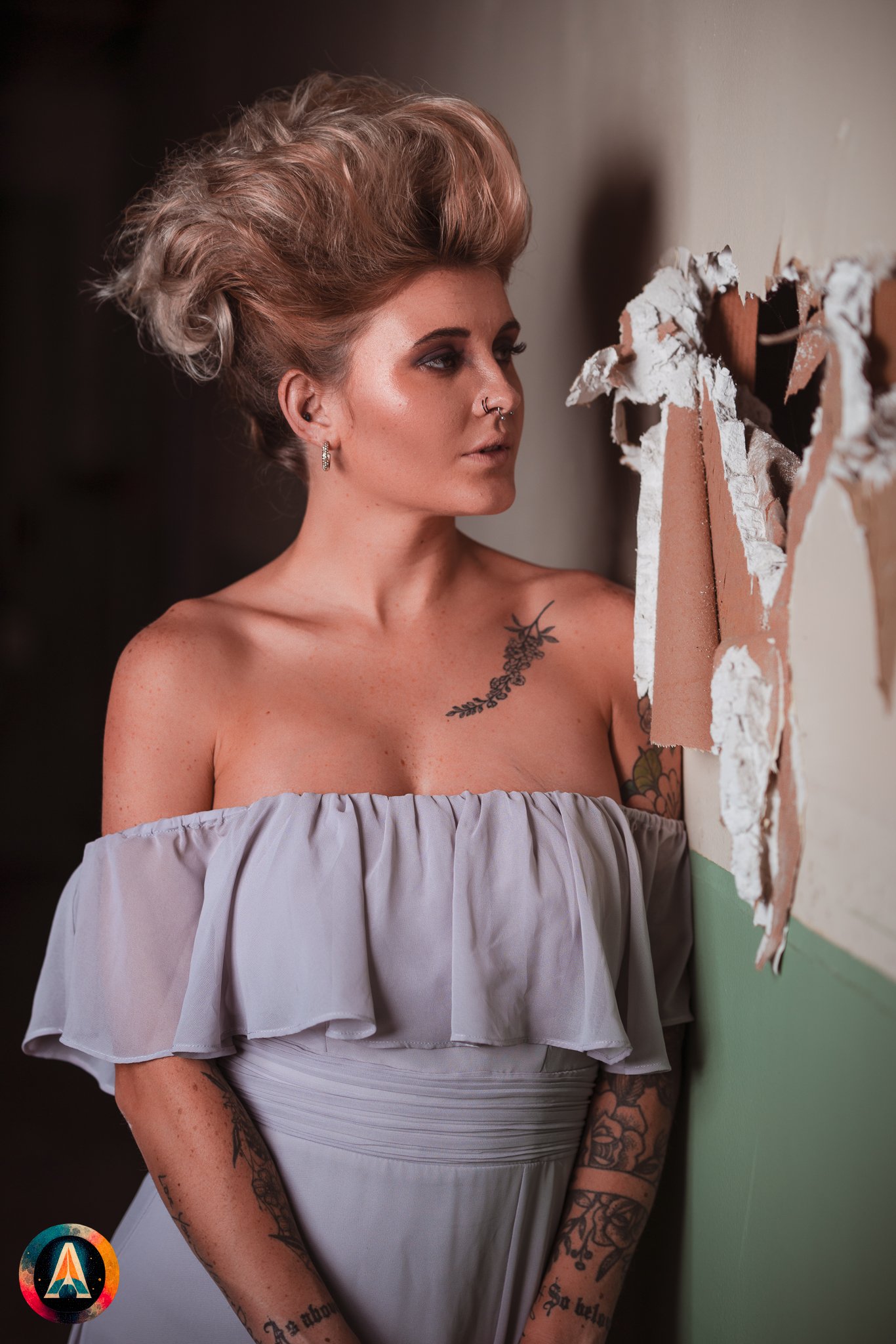 Blonde model courtney france poses in the haunted indiana state sanitarium shop / hair salon in a elegant blue dress.