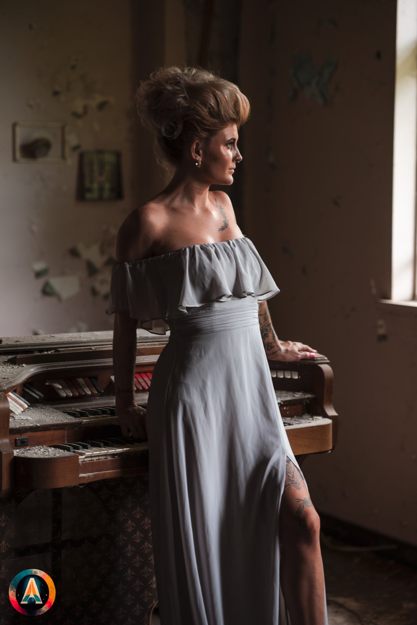 Blonde model courtney france poses in the haunted indiana state sanitarium shop / hair salon in a elegant blue dress.