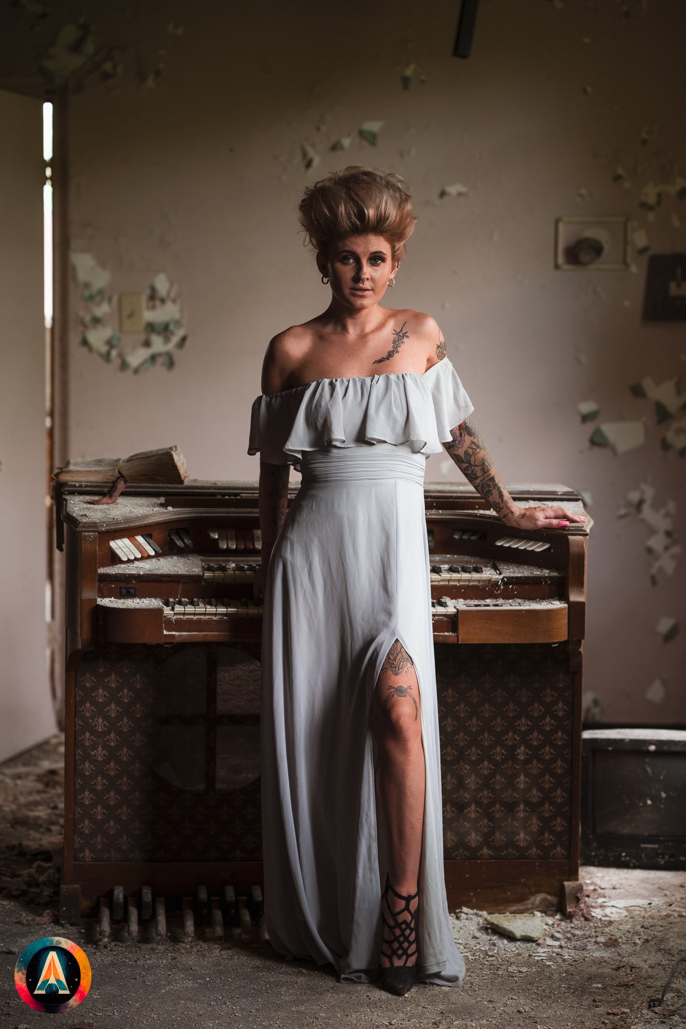 Blonde model courtney france poses in the haunted indiana state sanitarium shop / hair salon in a elegant blue dress.