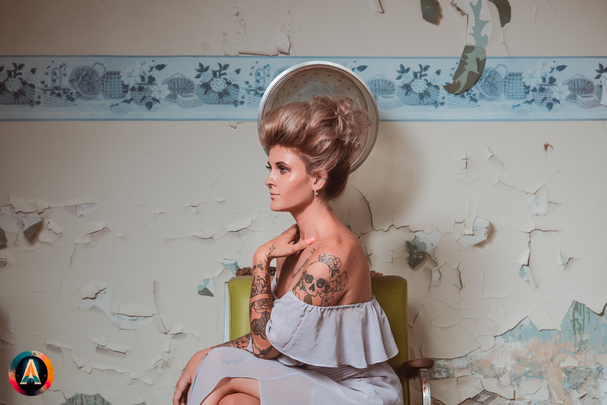 Blonde model courtney france poses in the haunted indiana state sanitarium shop / hair salon in a elegant blue dress.