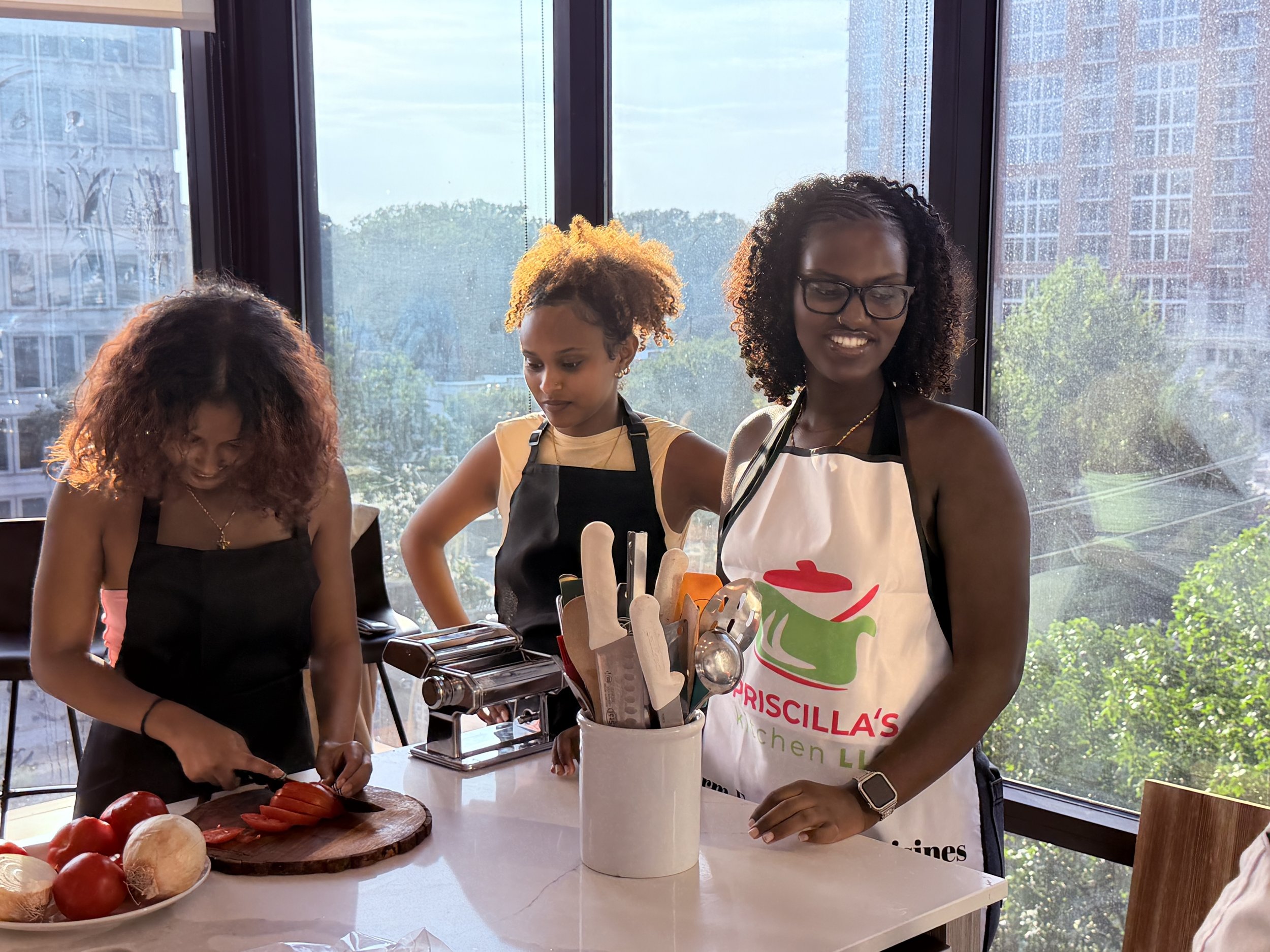 Three women in aprons, one with