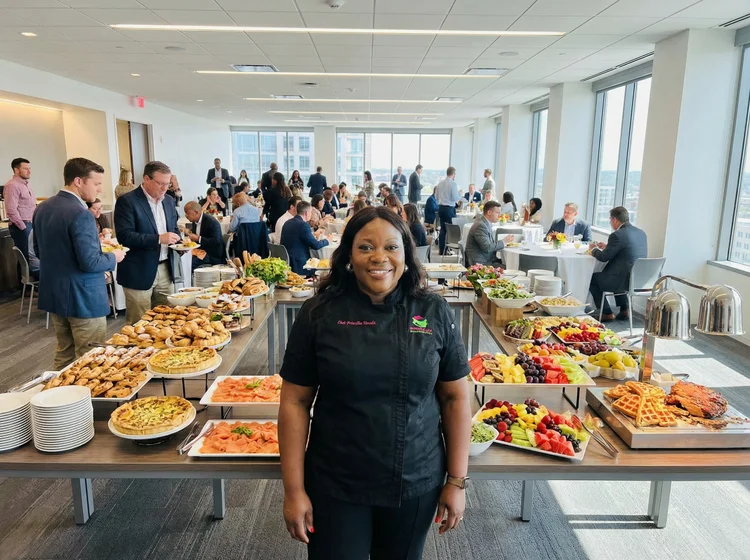 Various toppings on toasted baguette slices, including chopped tomatoes, cucumbers, sun-dried tomatoes, mushrooms, and cured meats, arranged on a white cloth with blue stripes.