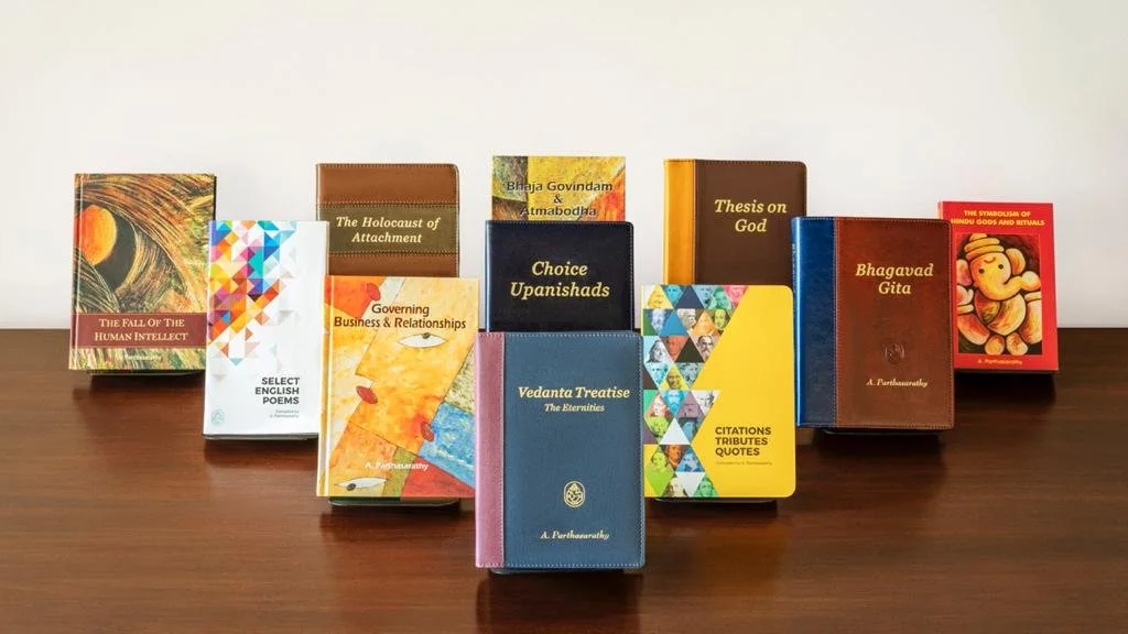 Group of young adults sitting outdoors, smiling and writing in notebooks, with sunlight in the background.