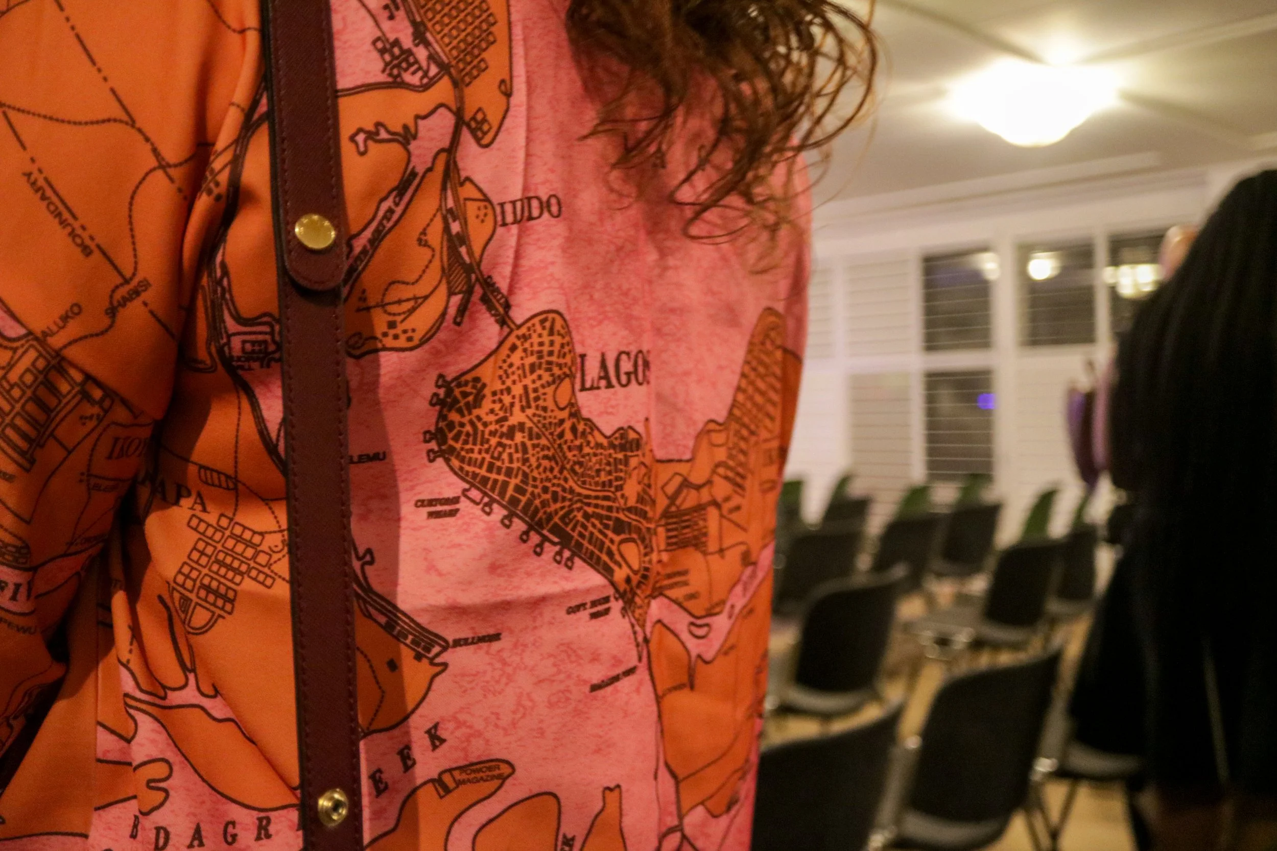 Cartographic Textiles: Detail of narrative-driven apparel mapping urban spaces and boundaries.