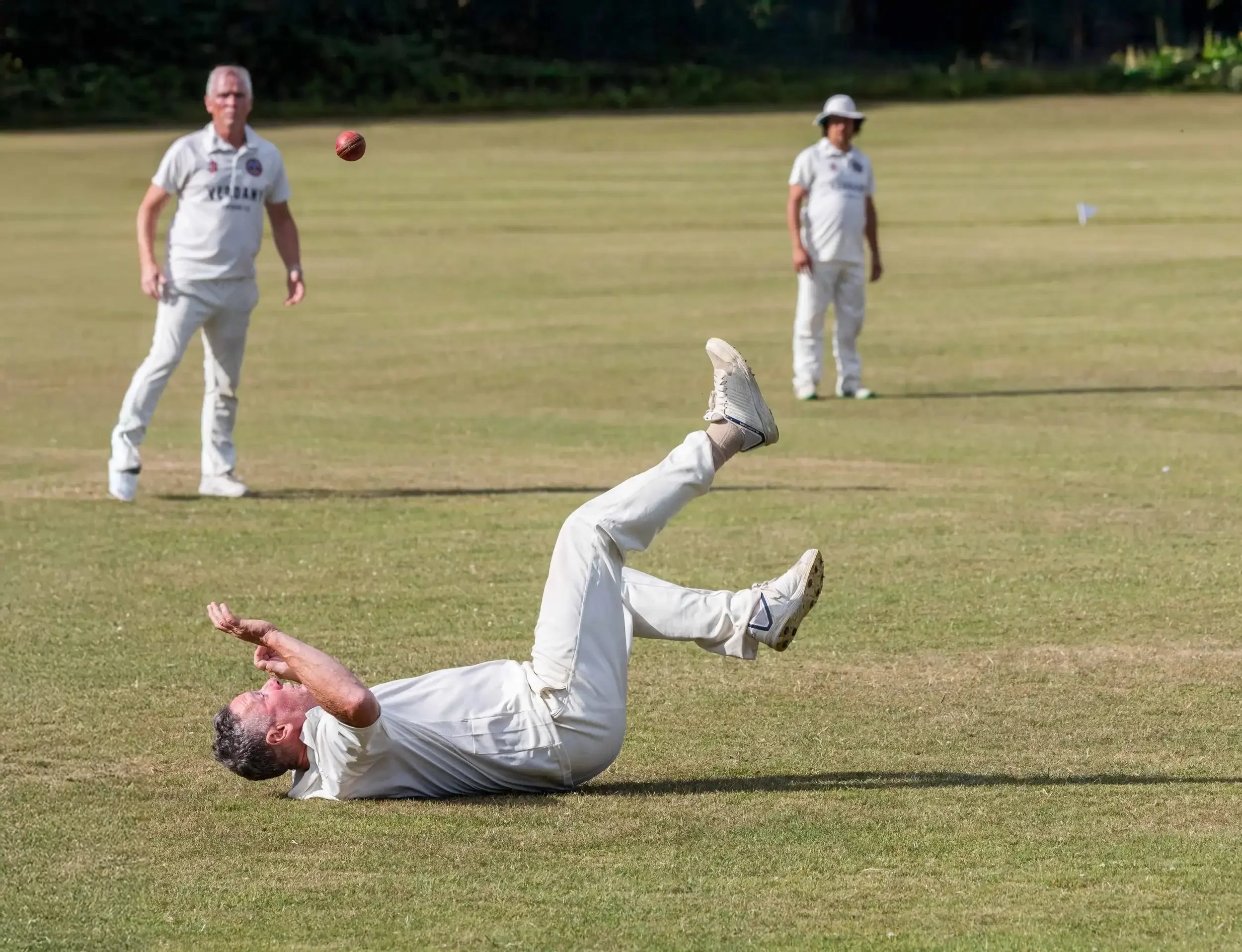 A humorous sports photograph of a dropped catch during a Seaview Old Boys cricket match in Falmouth, Cornwall, from the 2024 award-winning series by Matthew Morgan.