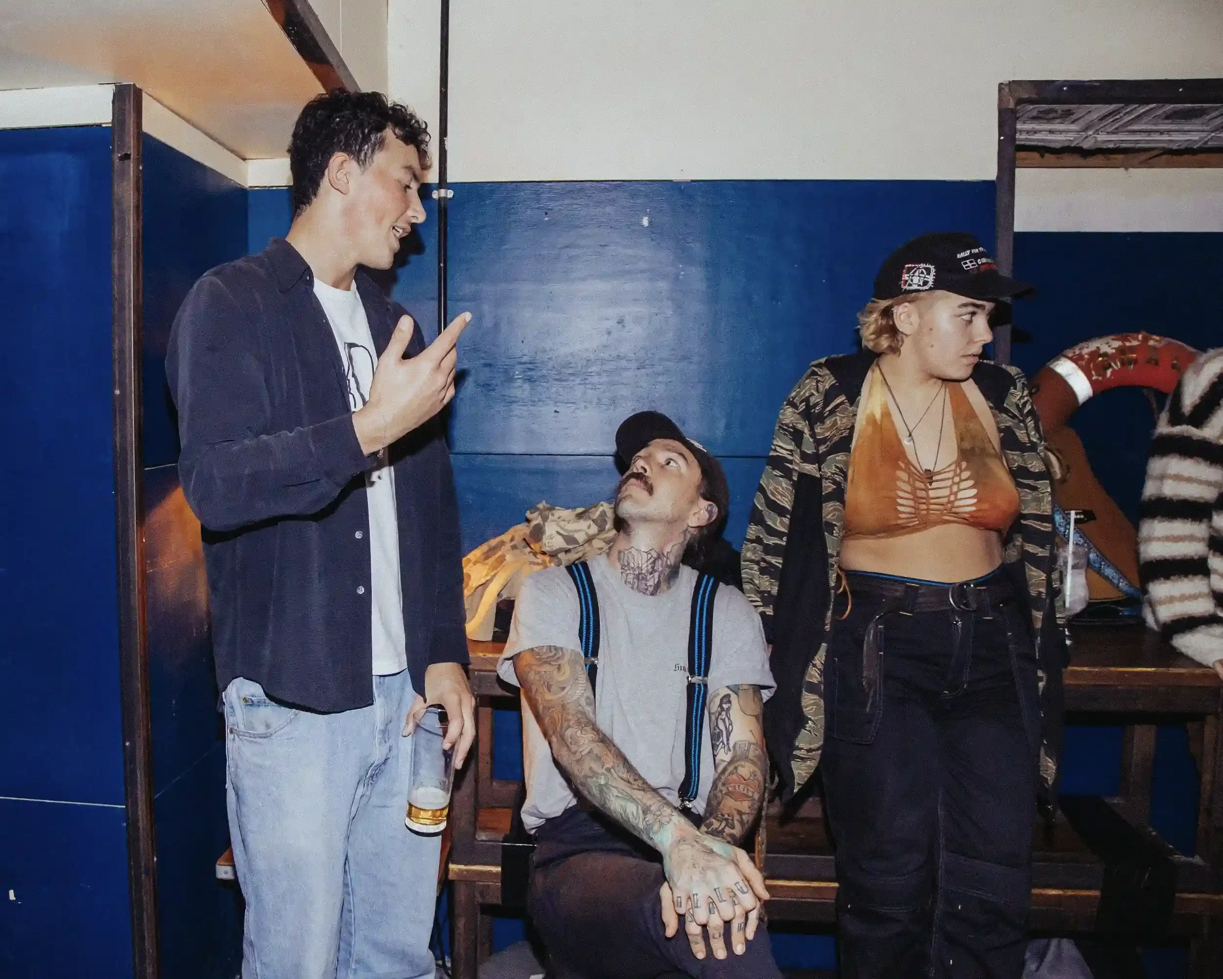 Authentic event photography by Matthew Morgan at Small Ships bar. This documentary-style shot captures a group of patrons in a candid moment, highlighting the venue's gritty, high-energy '5-star dive bar' atmosphere during a charity fundraiser.