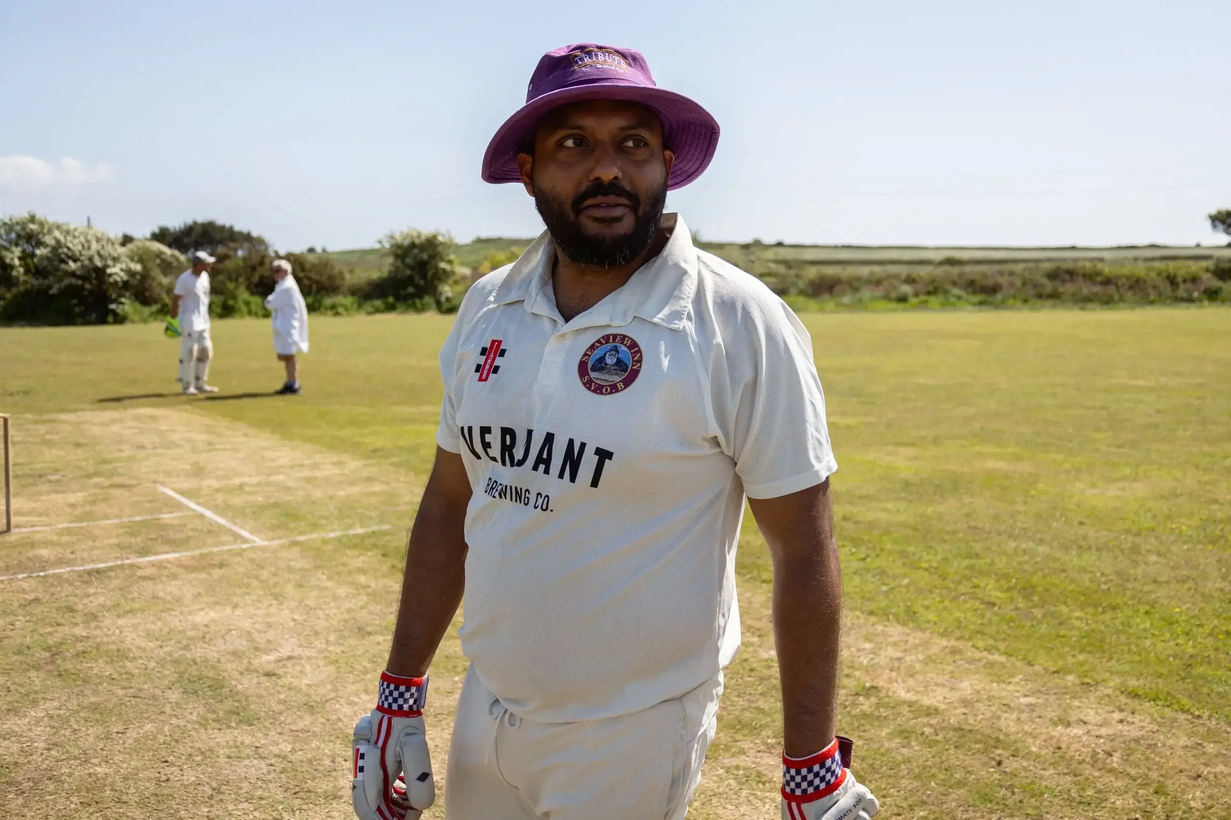 Portrait of Wribhu at the crease at Nancledra Cricket Ground, Cornwall, from the award-winning Seaview Old Boys series by Matthew Morgan, winner of the 2024 Press & Editorial Sport Series.