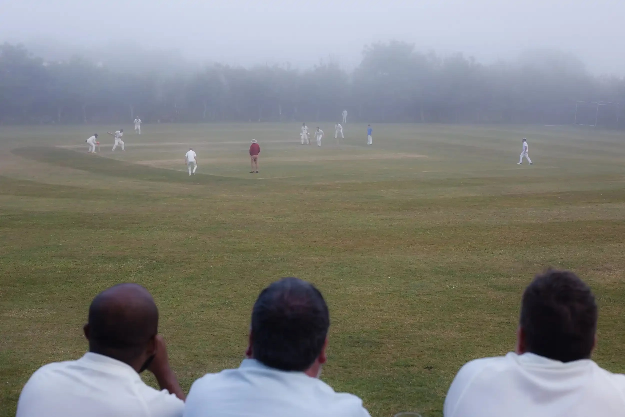 Spectators watching a Seaview Old Boys match through thick fog at Wendron Cricket Club, by award-winner Matthew Morgan.