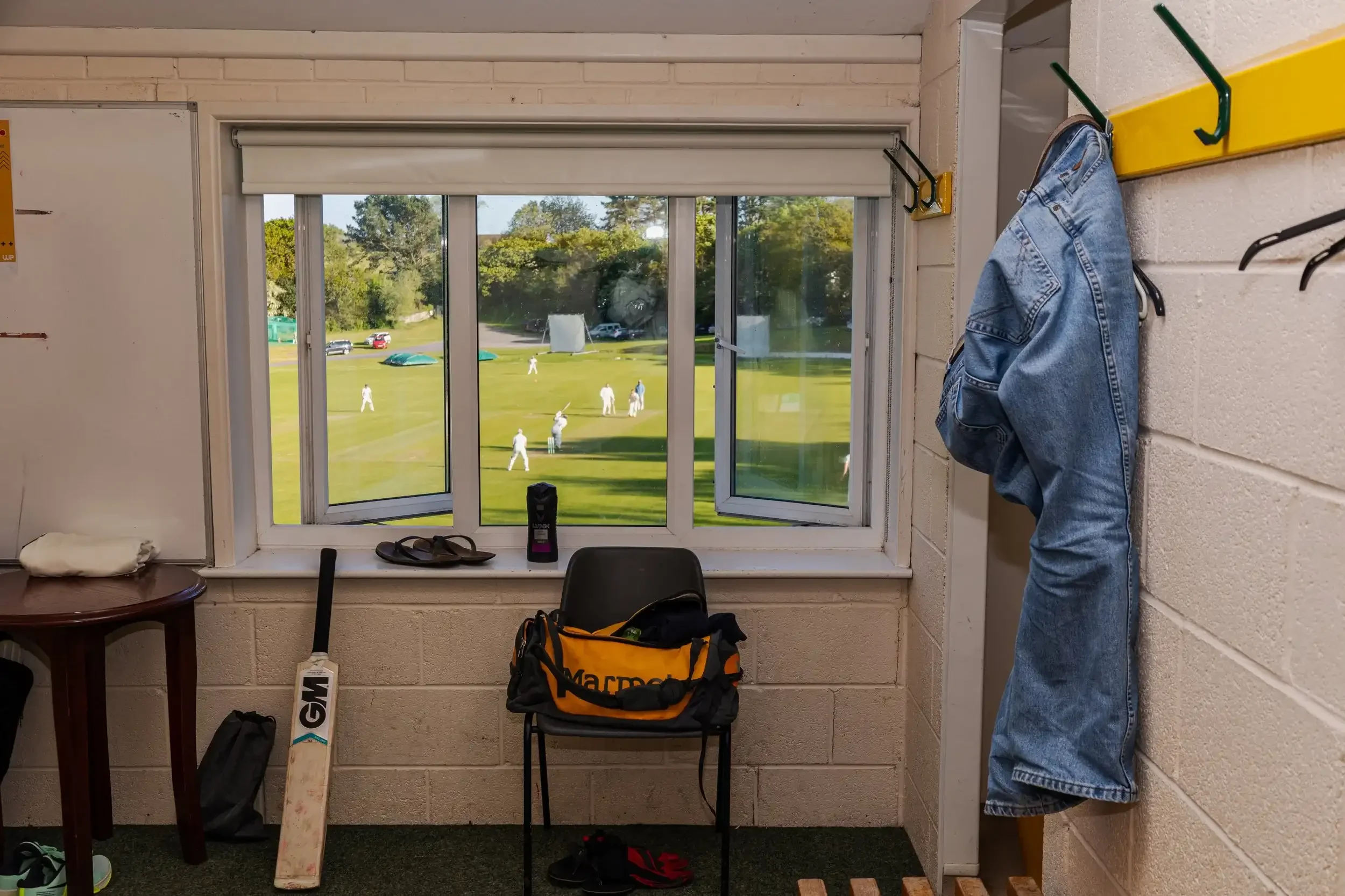 A candid documentary shot of the Seaview Old Boys cricket team in the Falmouth Cricket Club dressing room during a Mining League match, by award-winning photographer Matthew Morgan.
