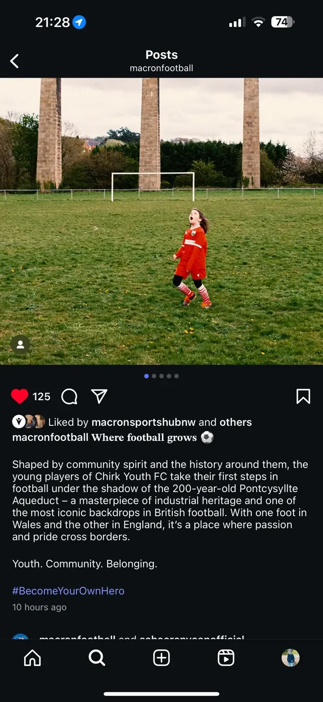 A screenshot of a professional Instagram post from 'macronfootball' featuring a photograph by Matthew Morgan. The image shows a young football player in a red kit looking up at a ball in front of the massive stone pillars of the Pontcysyllte Aqueduct