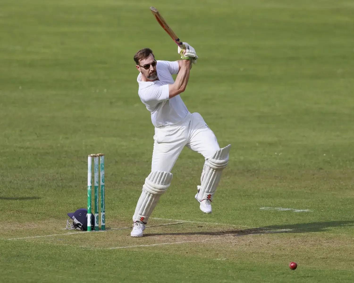 A Seaview Old Boys player wearing sunglasses while batting at Falmouth Cricket Club, by award-winner Matthew Morgan.