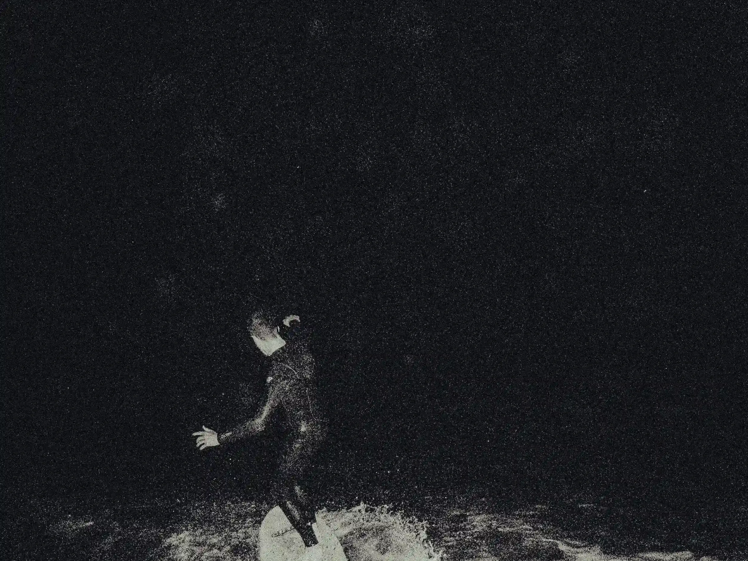 A Desperate Surf, Gyllyngvase Beach, midnight skimming, Falmouth surf photography, black and white action, Cornish youth culture, Matthew Morgan photography, grainy film aesthetic, night surfing Cornwall, Killigrew Inn surfers.webp