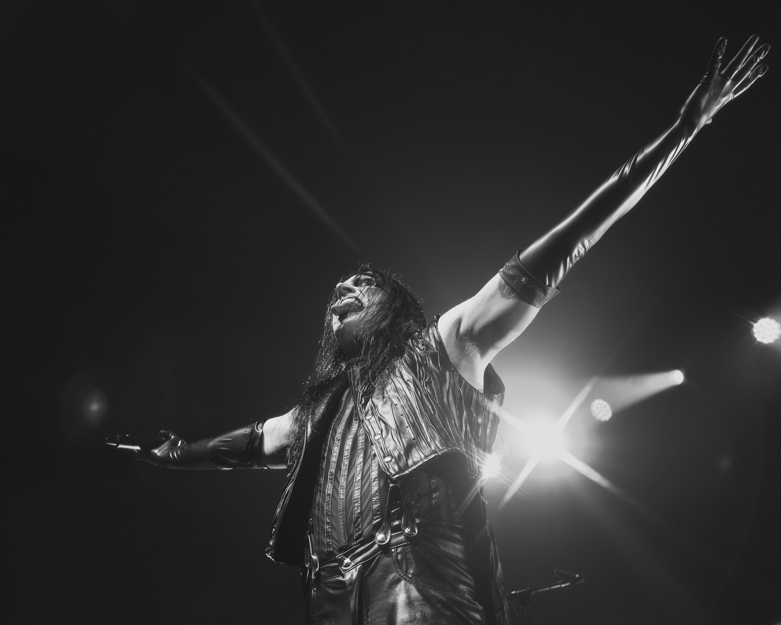 Live concert photography capturing an artist mid-performance with controlled stage lighting.