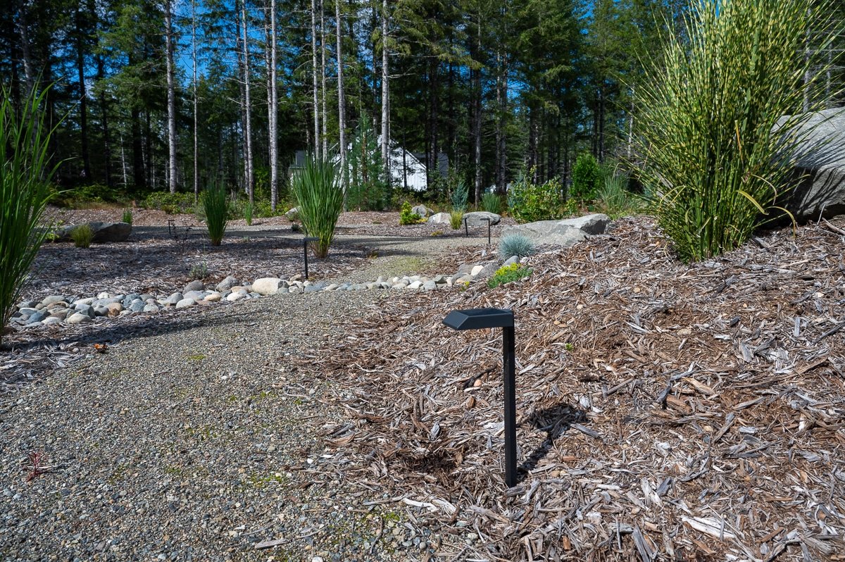 Black LED light along a garden pathway.