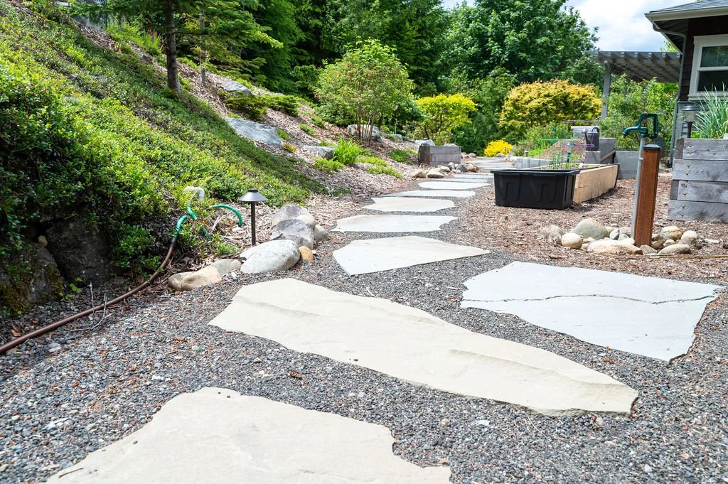Large spaced slate patio with gravel inbetween.