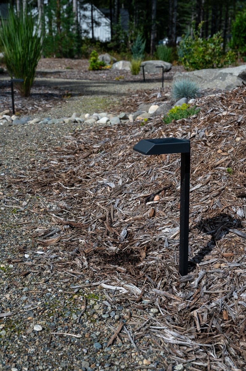 Wood chipped garden with a modern LED light on the edge.