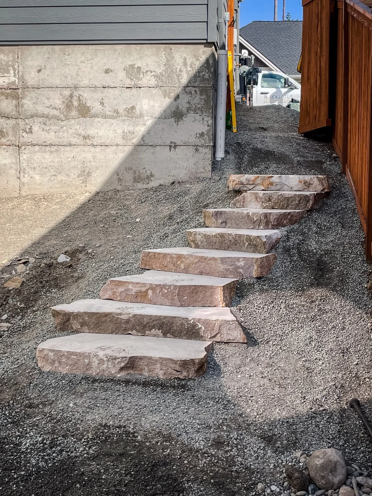 Stone stairs along the side of a house.