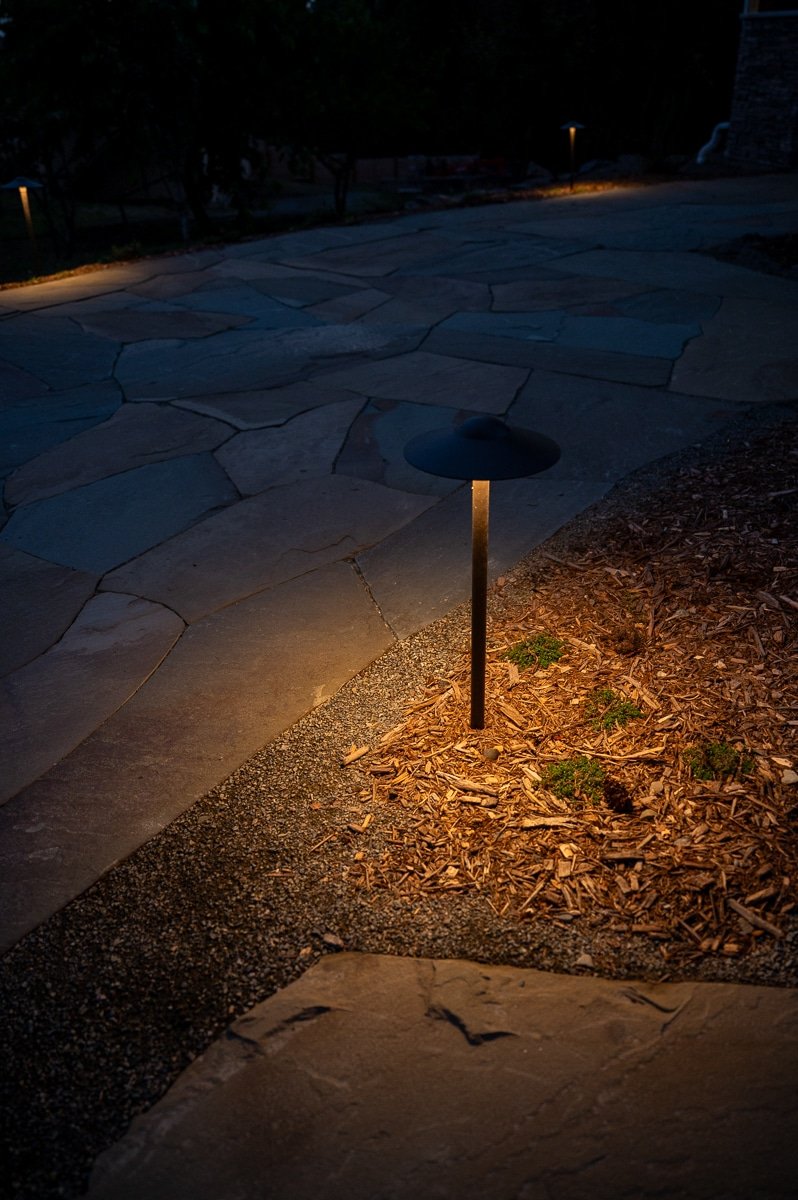 Soft LED lights along a slate path.
