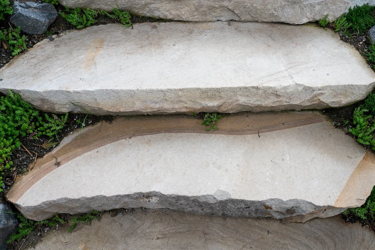 Looking down as stone stair treads.