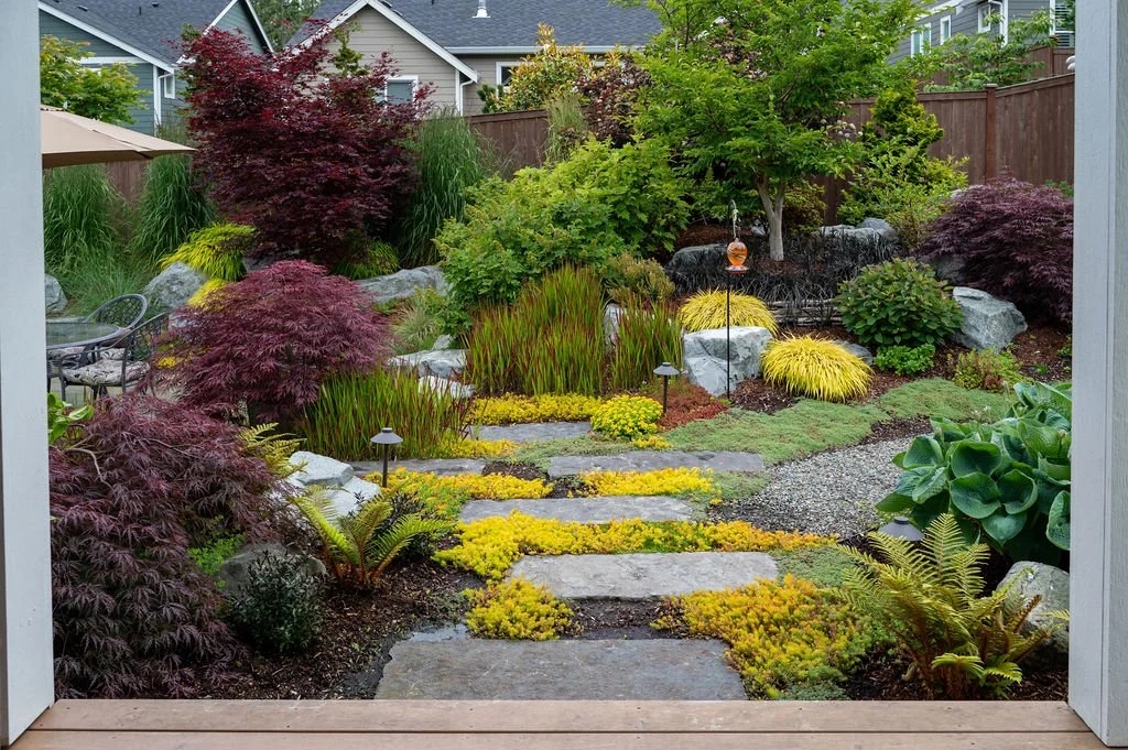 Back porch framing a luscious garden.