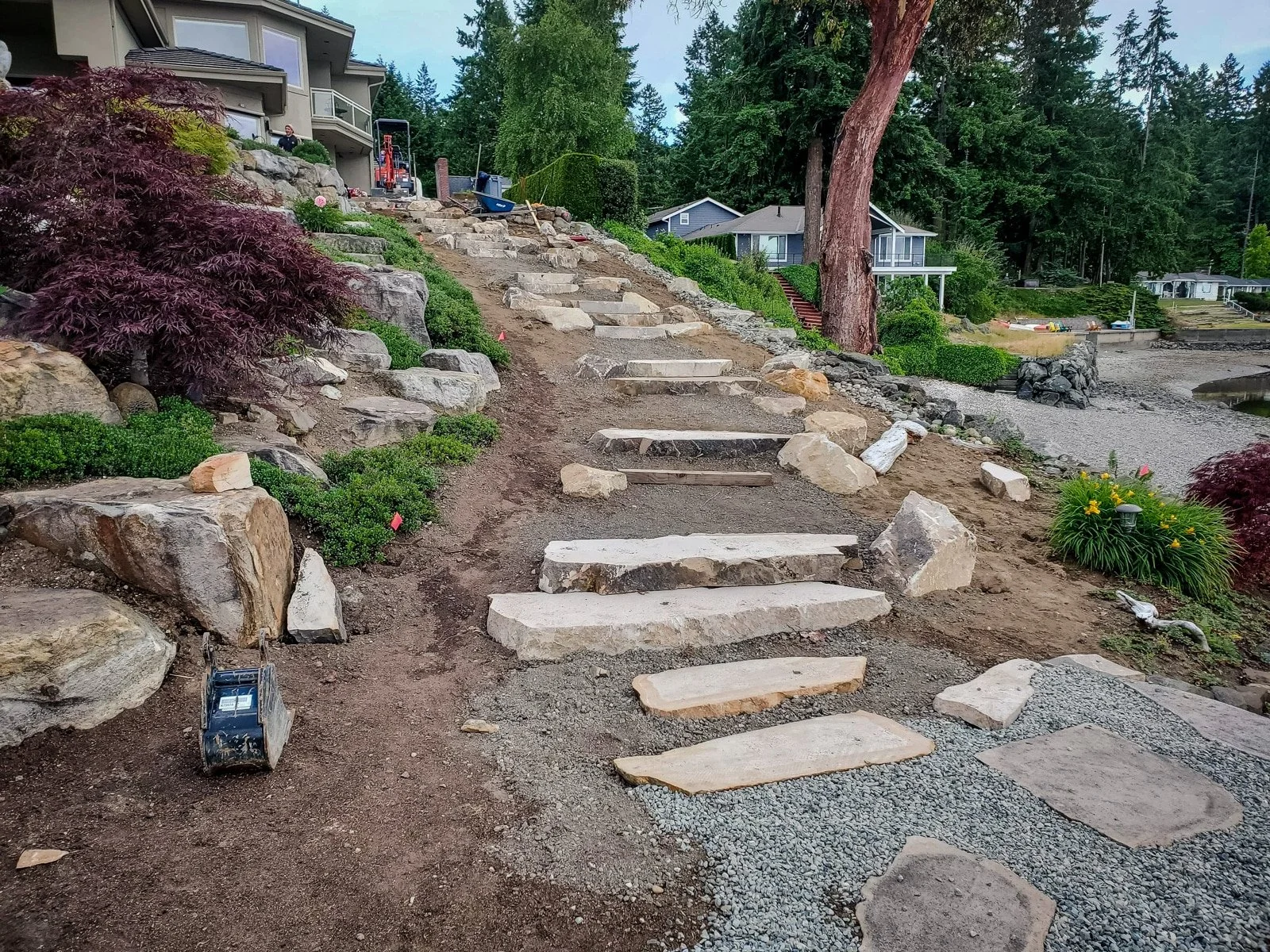 Gravel landing leading to a sandstone staircase.