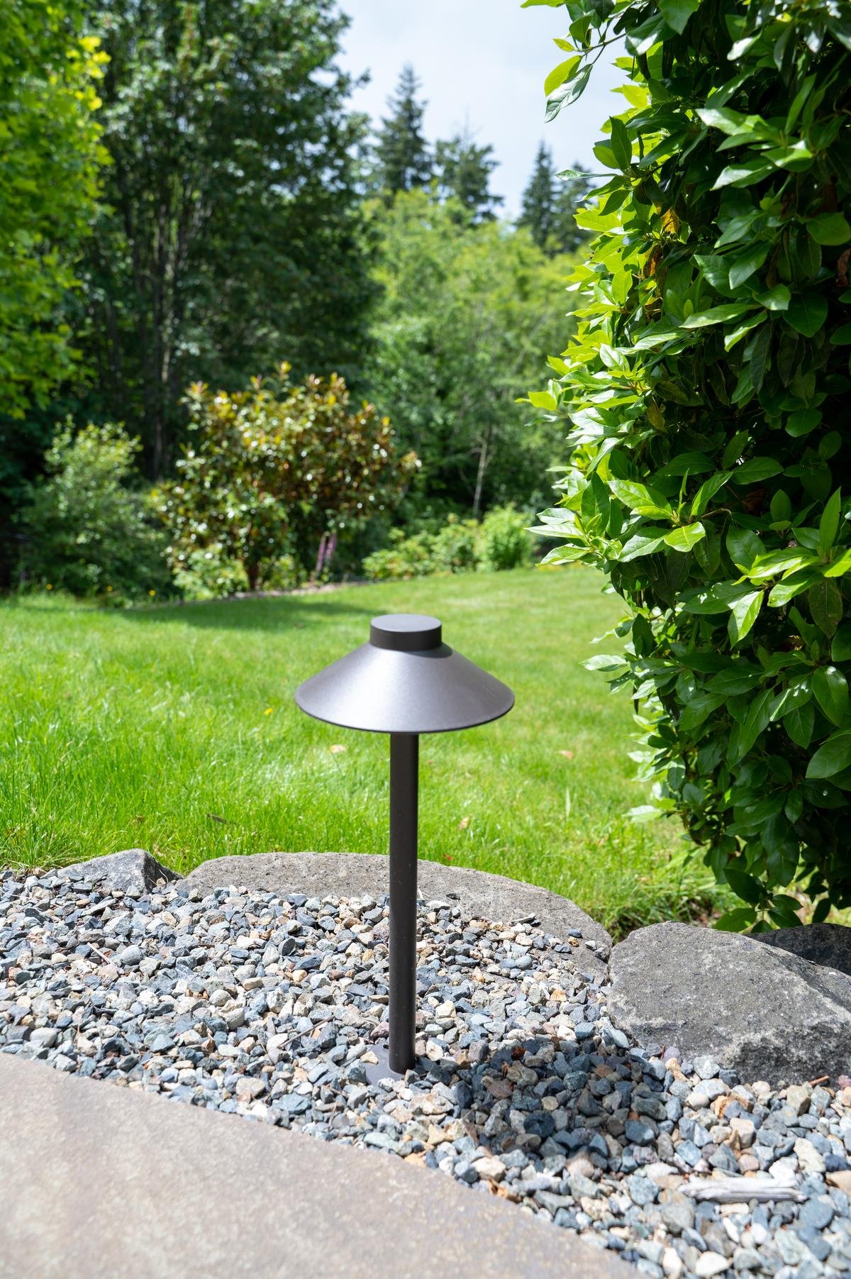 Pathway light in a gravel landscape bed.