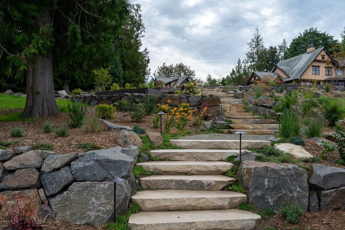 Stone staircase with retaining wall on either side.