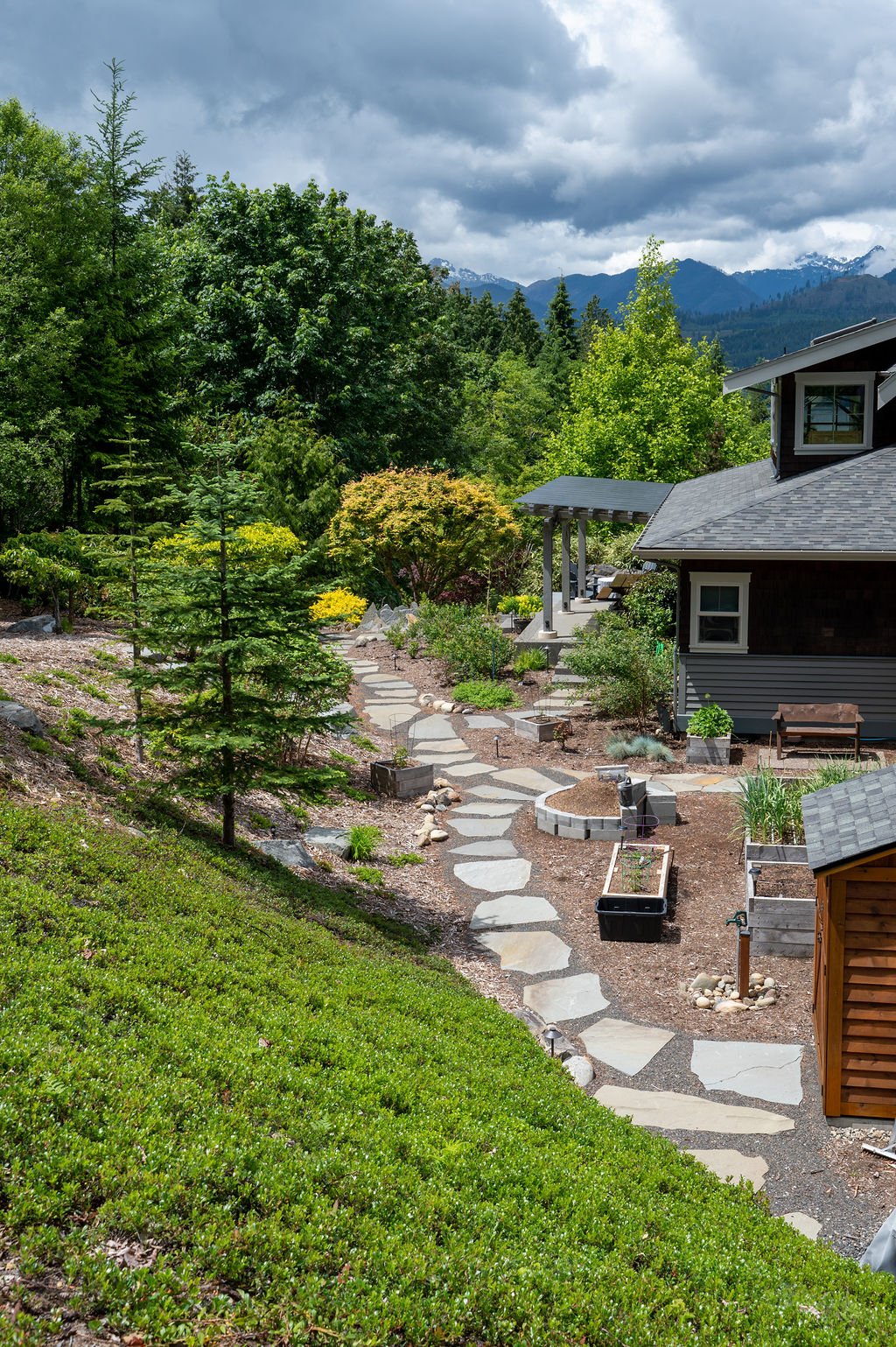 Grassy hill over a stone walkway.