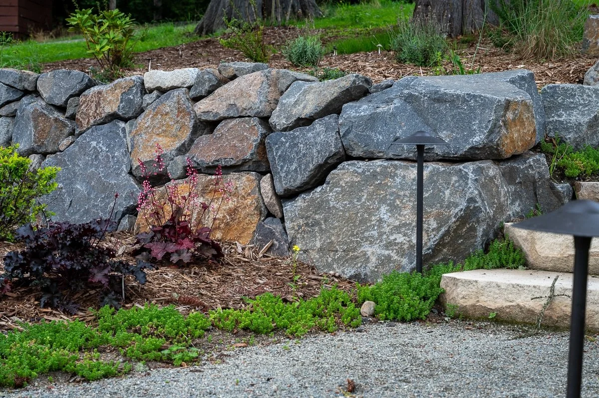 Hand stacked retaining wall.