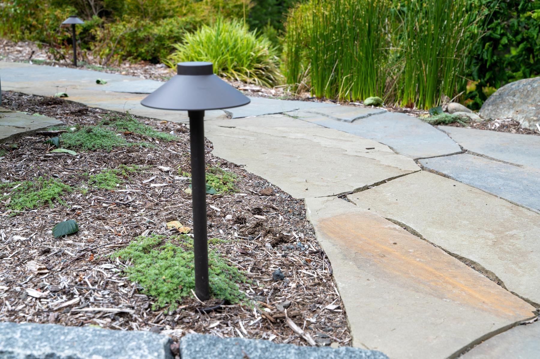 LED pathway light along a slate walkway.