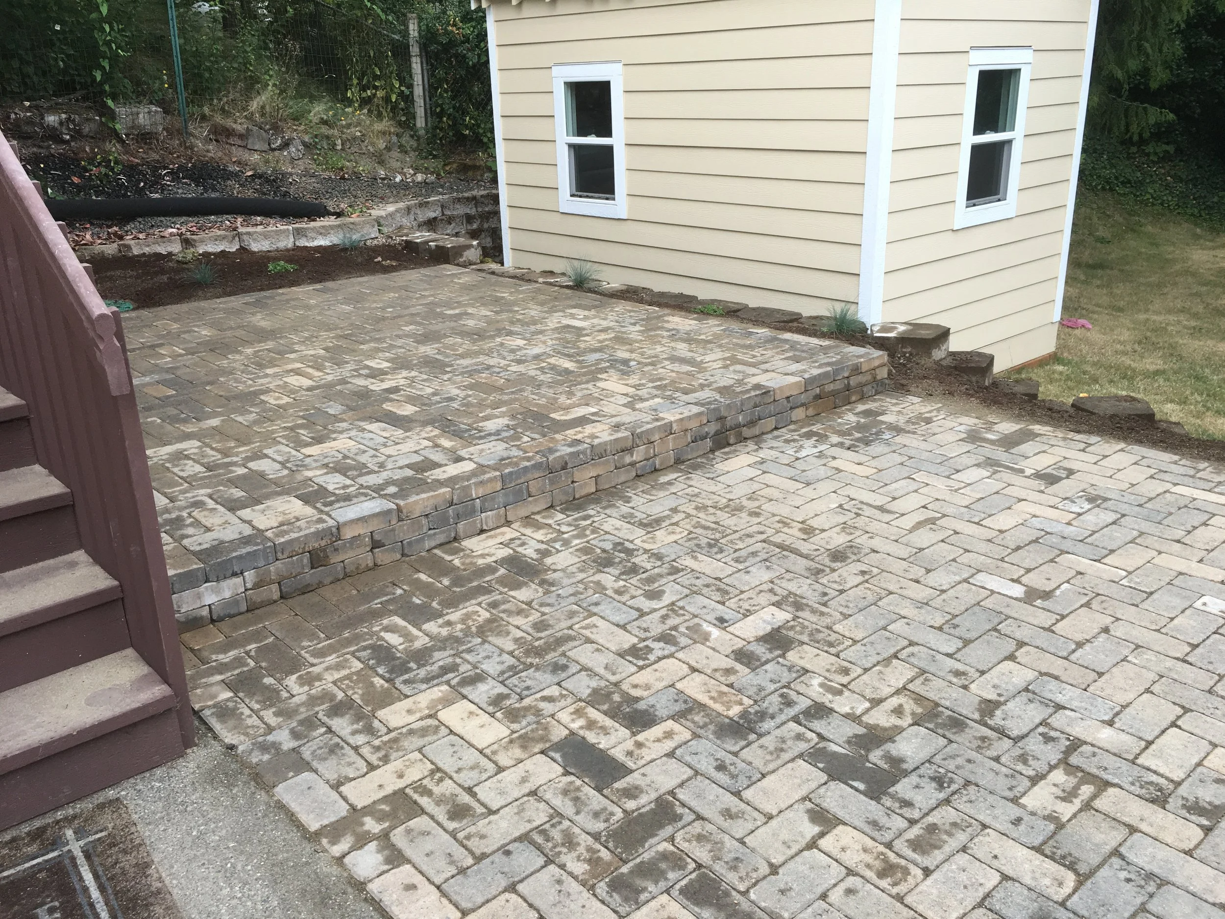 Large paver patio with step down.