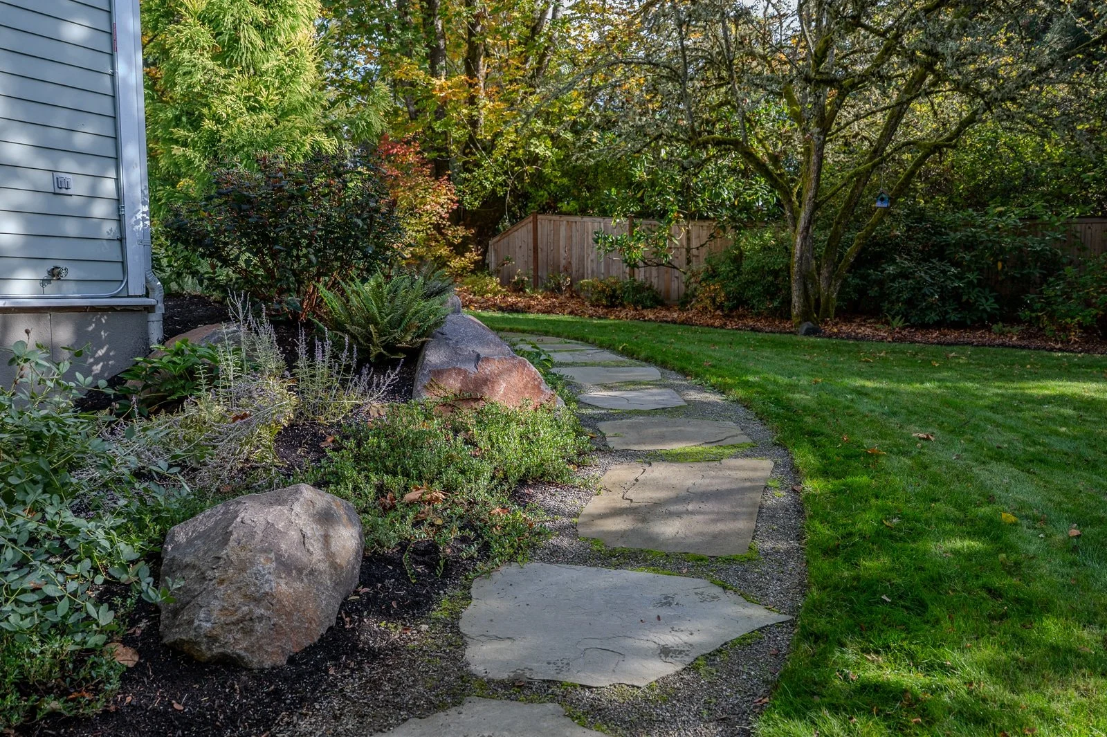 Slate walkway boardering a lawn and planting bed 1.jpg