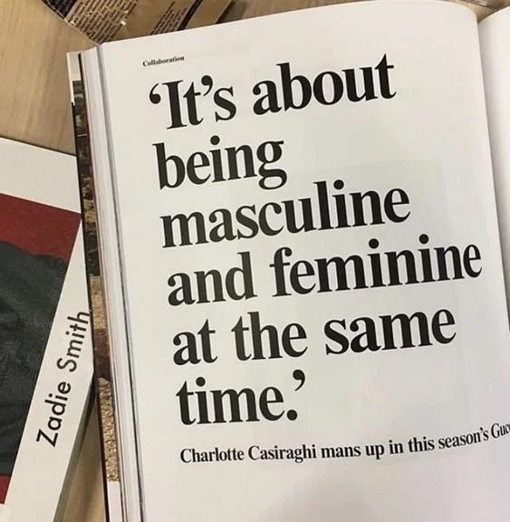 Magazine page with quote on gender expression, books nearby.