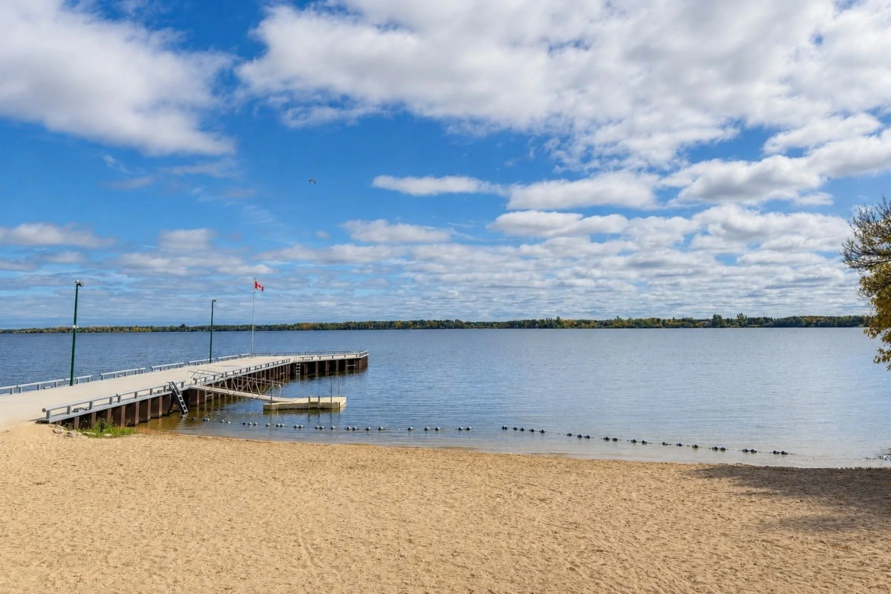 Lac du Bonnet Town Dock and Beach showing the dock, swim platform, buoyed area, and sandy beach