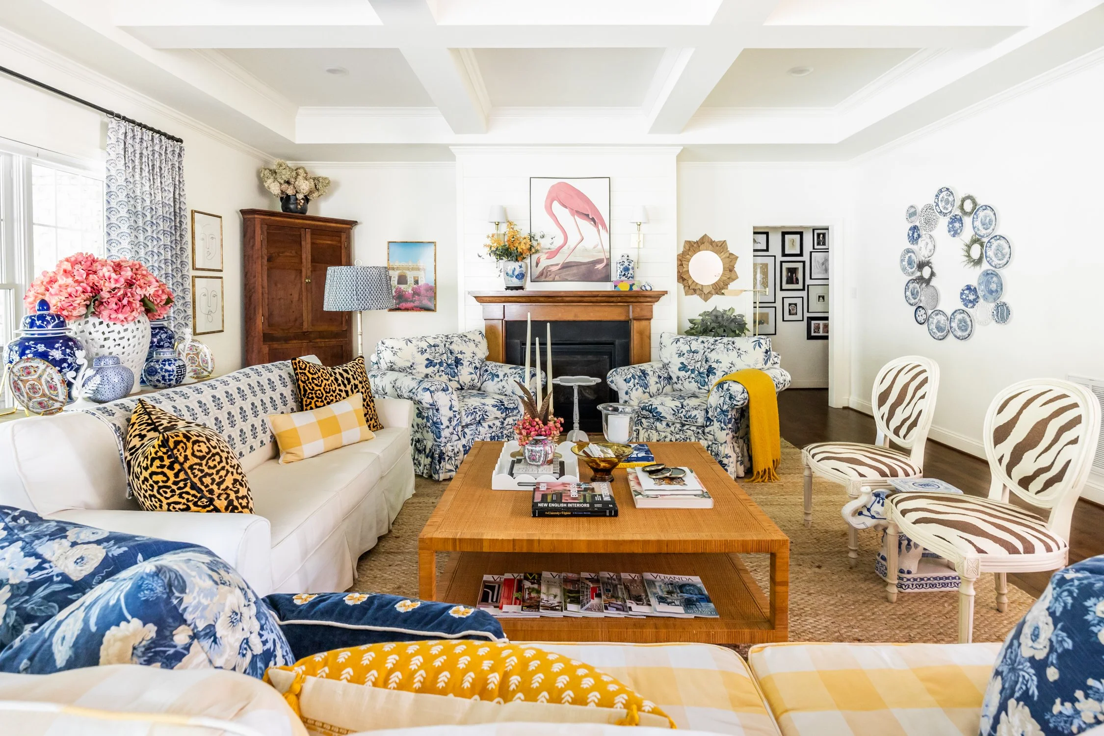 Living room with custom drapes, upholstered chairs, and layered accessories in a refined, comfortable setting.