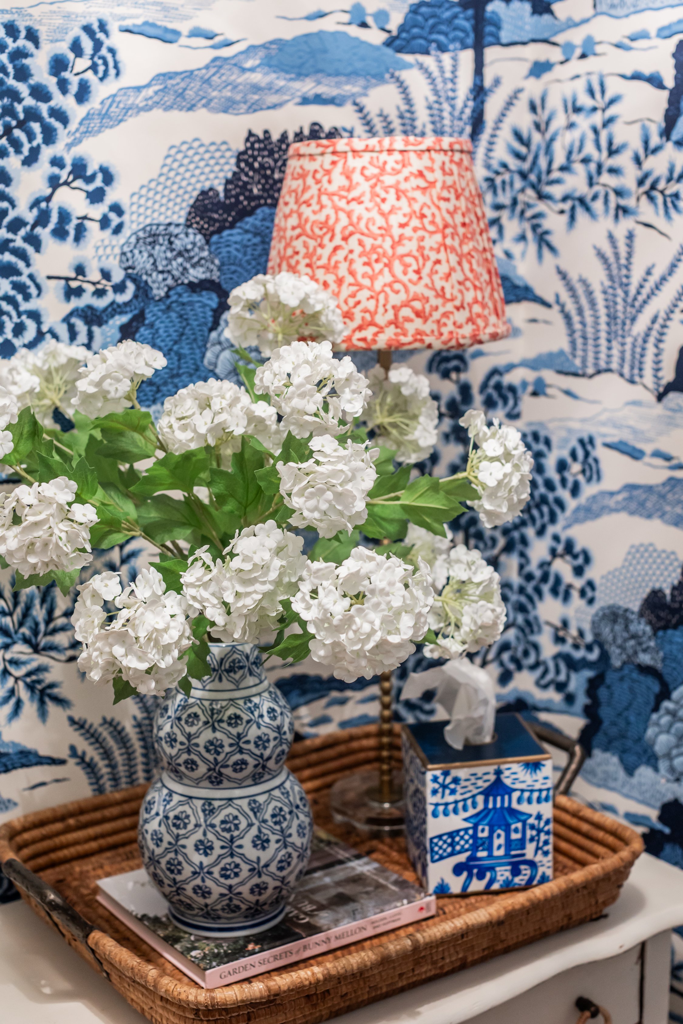 Powder room featuring patterned Thibaut wallpaper for a bold, statement look.