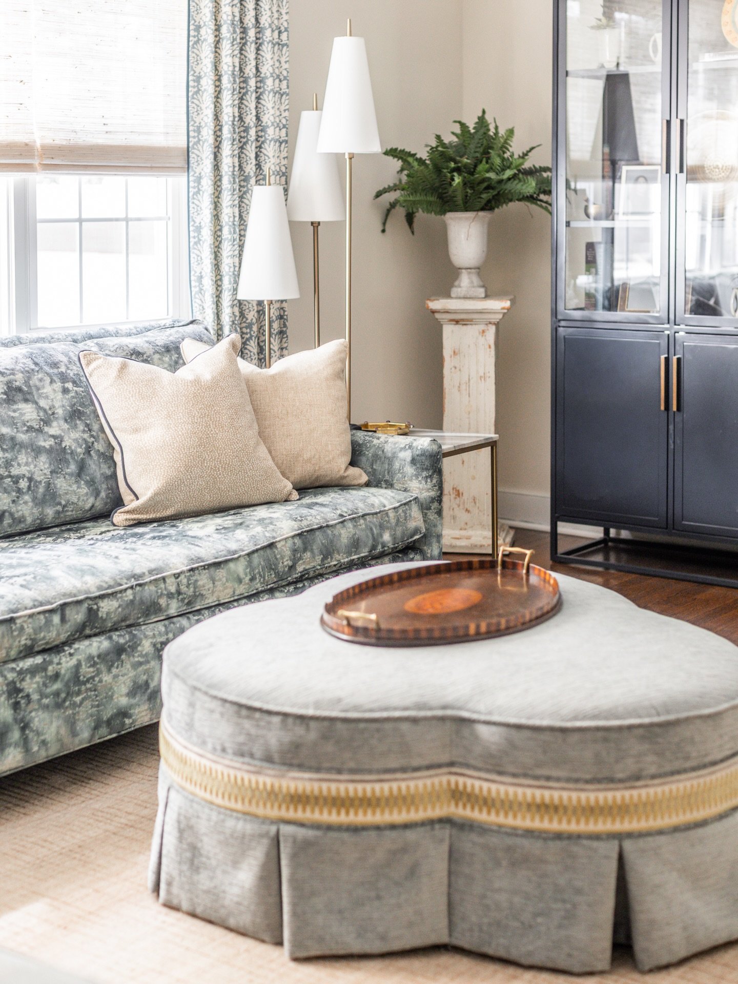 This living room came together beautifully with Design Consultant Diana Vicenti&rsquo;s help, starting with a fabric palette that feels serene and cohesive. Custom window treatments, reupholstery, and pillows work together seamlessly, with lighting, 