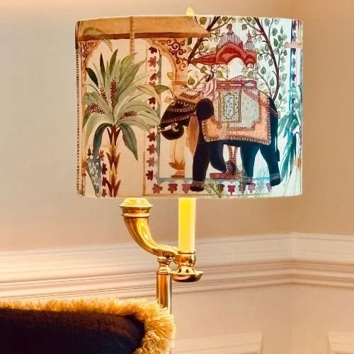 Lampshade with an Asian-inspired painting of a musician playing a stringed instrument under a tree, accompanied by a peacock and decorative elements.