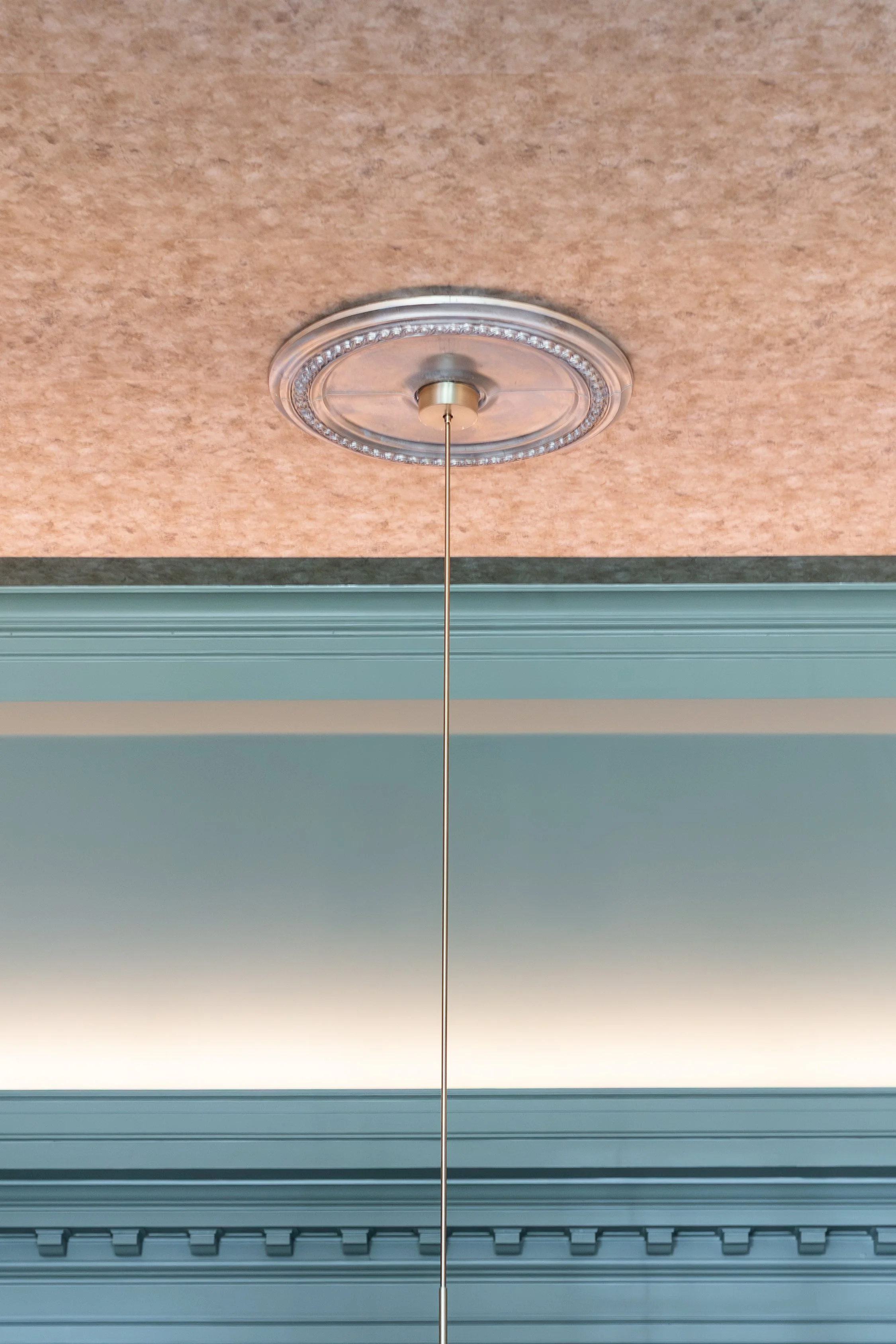 Fabricut Bastien metallic wallpaper in Burnished applied to the ceiling of the Living & Dining Room at the 2026 RSL Designer Show House at Foundry Manor, designed by U-Fab Interiors.