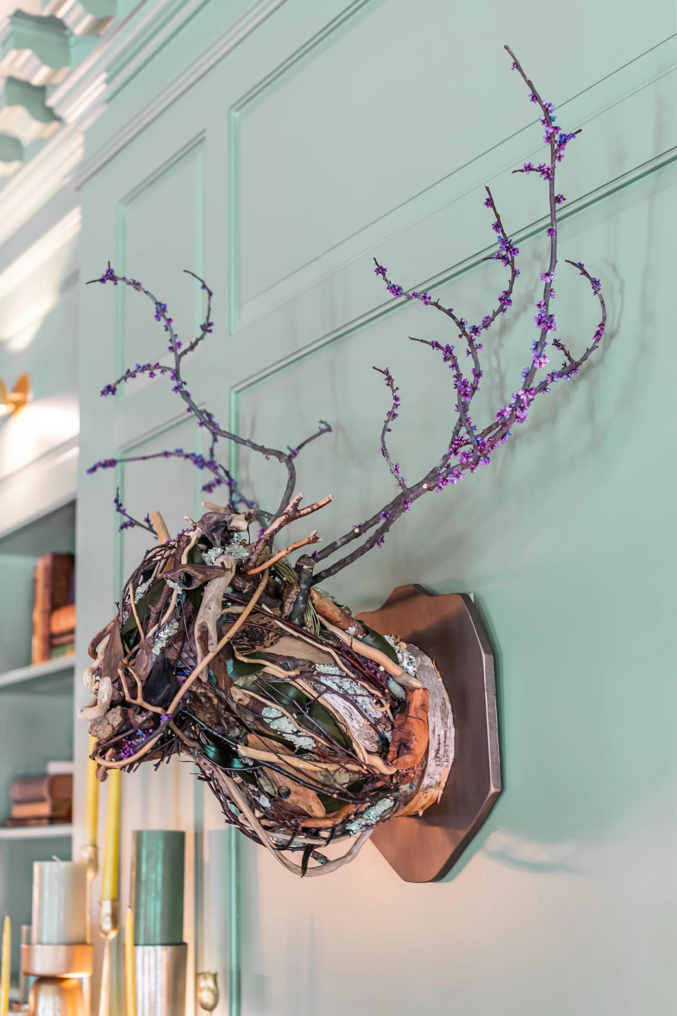 A one-of-a-kind deer bust handcrafted by U-Fab Interiors designer Diana Vicenti using natural objects gathered on the grounds of Foundry Manor, featured in the Living & Dining Room at the 2026 RSL Designer Show House.