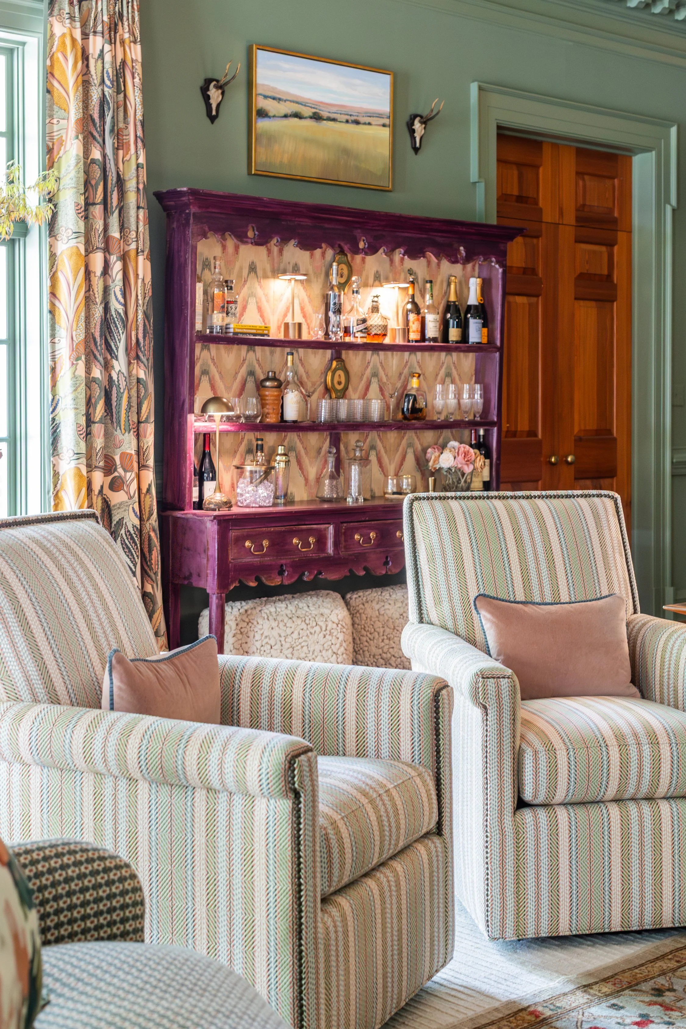 Josh Swivel Chair upholstered in Vision Oscoda in Sorbet by Valdese Weavers with nailhead trim, styled in the Living and Dining Room at Foundry Manor for the 2026 RSL Designer Show House, featuring Albero drapery panels by Thibaut