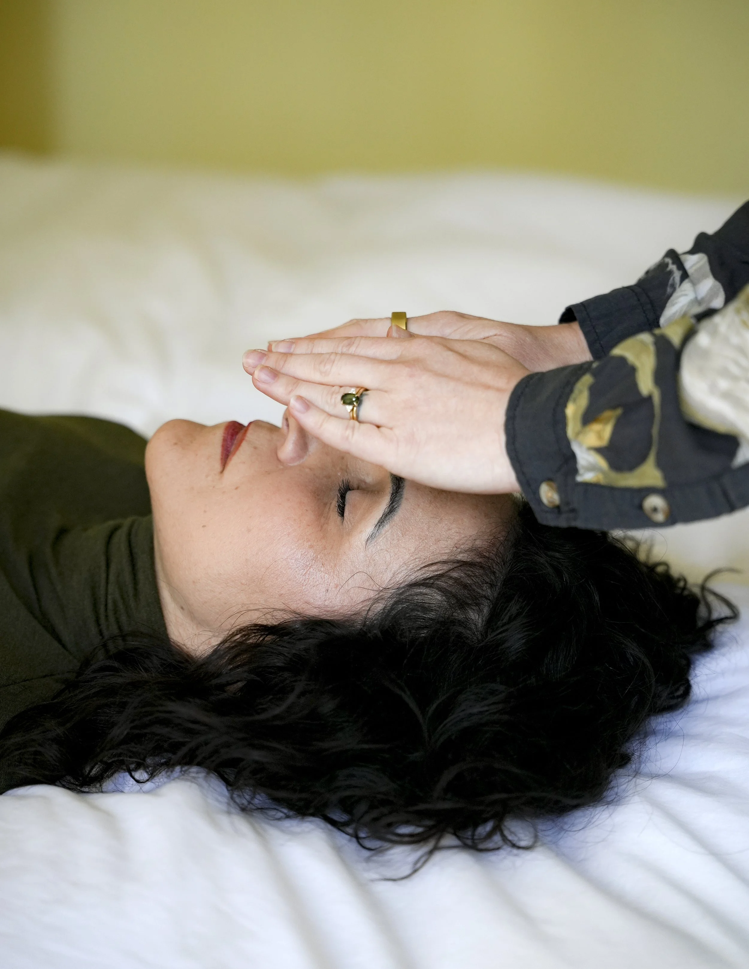 Promotional poster for Reiki Healing session with a woman lying down, wearing a headscarf and relaxing, with text indicating a single session costs $85.