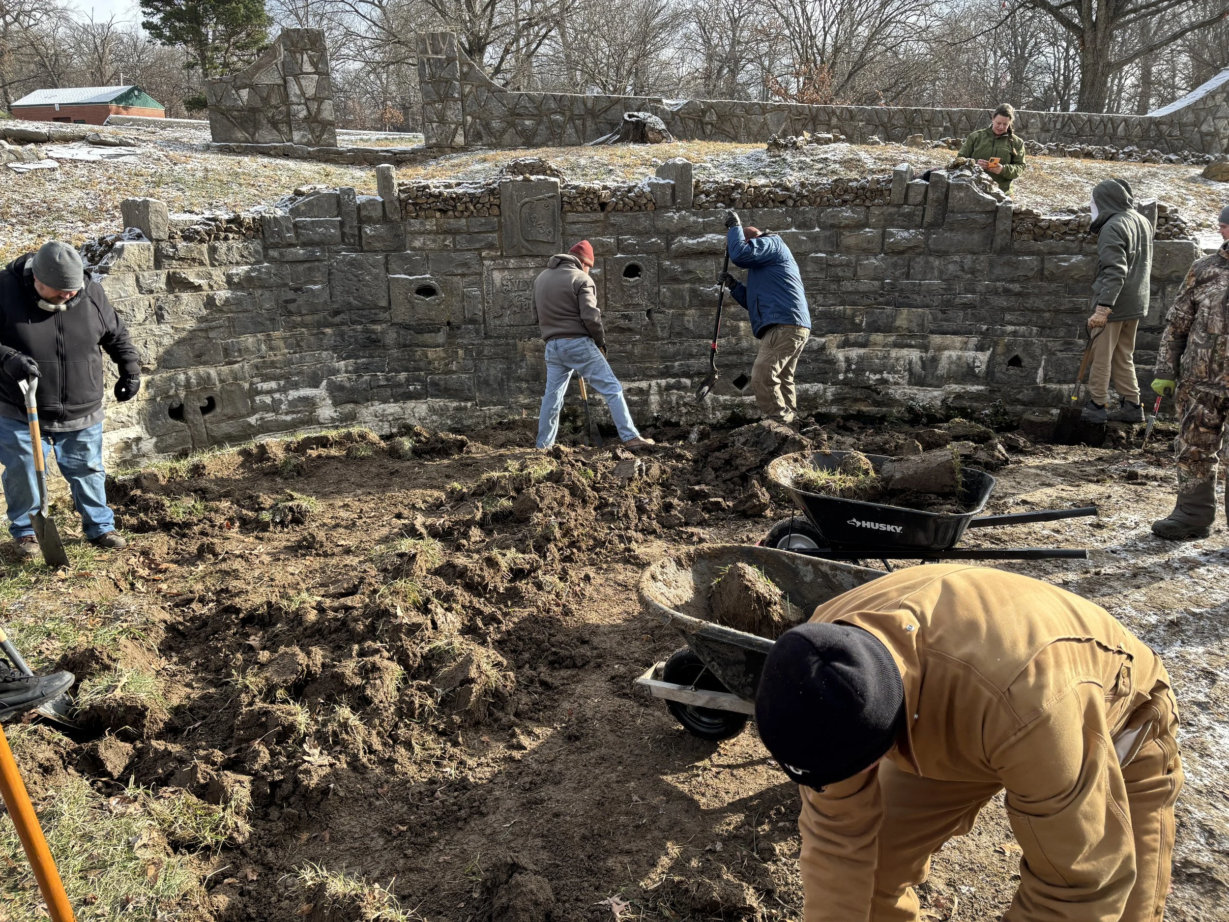  Volunteers clearing layers of soil and grass from the patio flagstone - photo by Erin Nichols