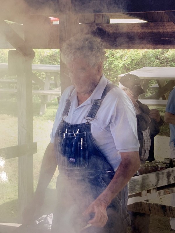 John R. Simon stands in the sweet steam arising from the sorghum pan during one of the later festivals before the event was retired.