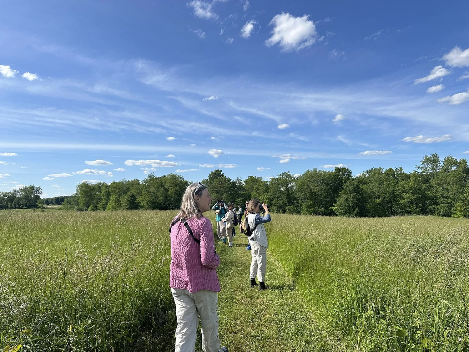 Assistant Teri Gilligan listening for bird songs.
