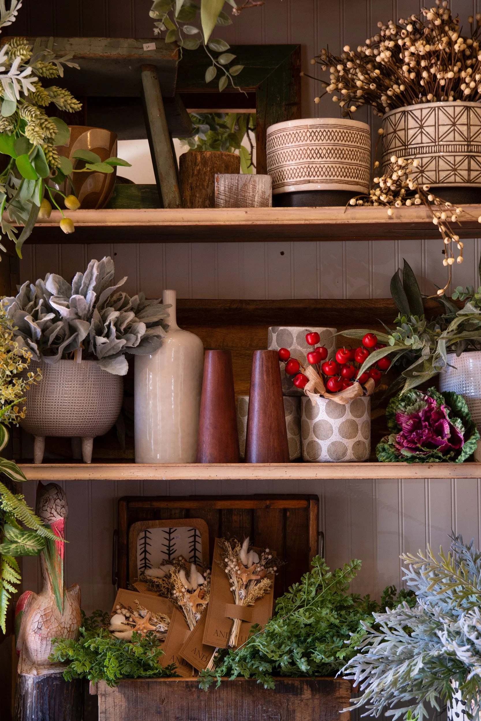 Decor, planters and greenery arranged on retail shelves inside Jacques in Skippack, Pennsylvania.