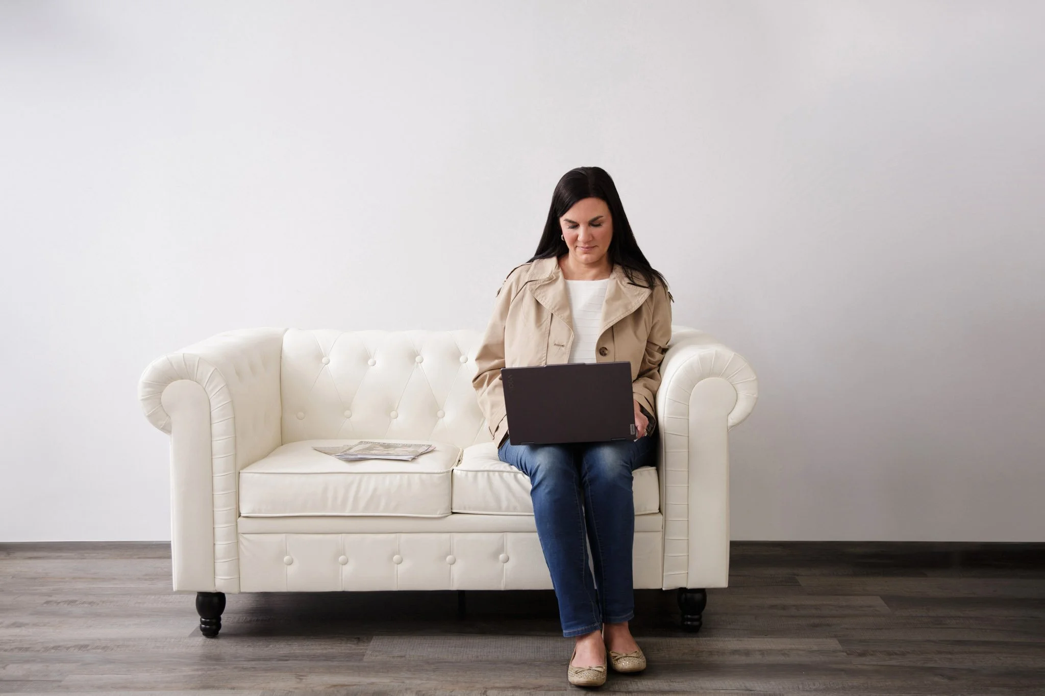 Branding photography session in Creamery, PA studio featuring local magazine publisher with laptop and magazines